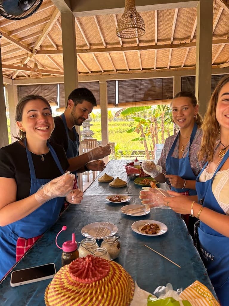 Traditional Balinese satay grilling during a half-day cooking class in Bali