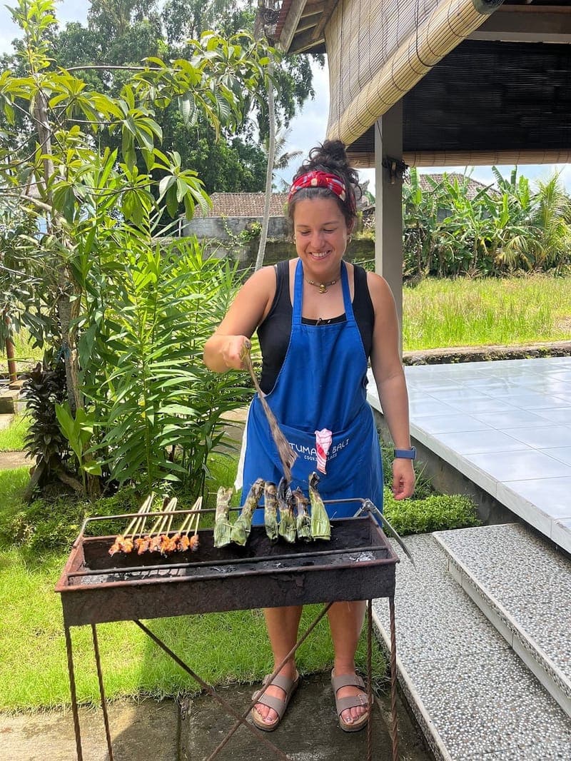 Guests enjoying an authentic Balinese cooking class in Ubud overlooking rice fields